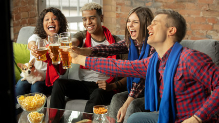 Winners. Excited people watching sport match, chsmpionship at home. Multiethnic group of friend, fans cheering for favourite national basketball, tennis, soccer, hockey team. Concept of emotions.