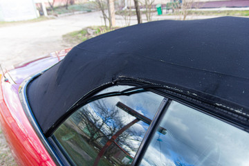 Convertible fabric roof repair, torn material, rubber seals.