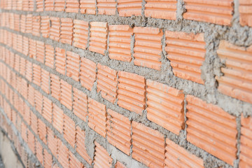 Obraz premium Close up view of a brick wall on a construction site, Construction concept.