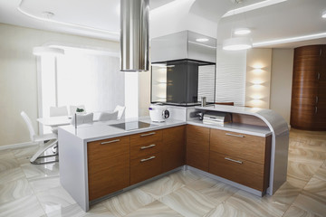View of luxury modern fitted kitchen with stainless steel appliances