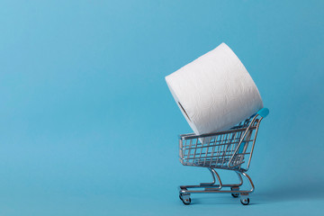 Roll of white toilet paper with a shopping cart on a blue background