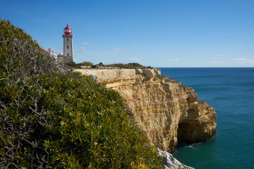Fototapeta na wymiar Farol de Alfanzina Lighthouse landscape in Algarve, Portugal