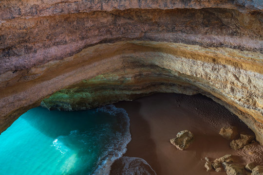 Benagil wild hidden secret cave beach top view above with turquoise paradise water in Carvoeiro, Portugal