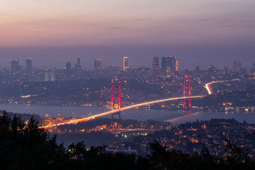 View from Camlica hill to 15 July Martyrs bridge with scyscrapers in the backgroun.d during the blue hour.Romantic  Istanbul.Turkey.