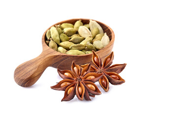 Cardamom and  anise in wooden spoon on white background. Spices isolated.