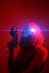 Girl with blaster in the futuristic battle. Concept virtual reality, cyber game. Image with glitch effect.