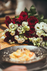 romantic dinner of man and woman with wine and flowers background at a restaurant  dinner for two a glass of wine salad on the plate