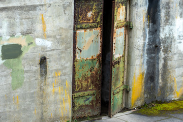 Close up of old rusty metal door and concrete wall at Fort Worden State Park in Port Townsend, Washington