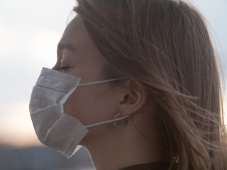 Beautiful Girl With Closed Eyes Wearing Medical Mask During Coronavirus COVID-19 World Epidemic
