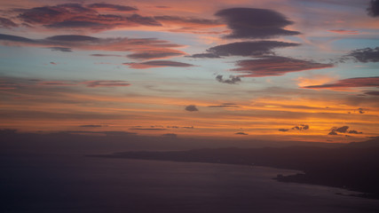 Fototapeta na wymiar Sunset from airplane with clouds