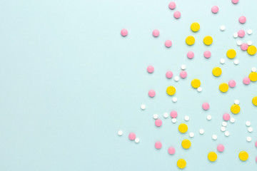 Colorful pharmaceutical medicine pills and tablets different medical drugs on blue background. Medicine flat lay.