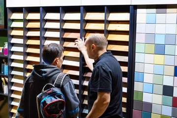 Men in shop of colored wooden panels
