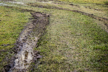 dirty mud road in winter with water on the road surface