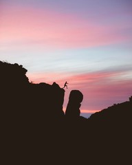 silhouette of man on top of mountain