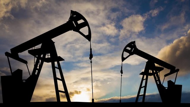Oil pump on a sunset background. World Oil Industry. Timelapse