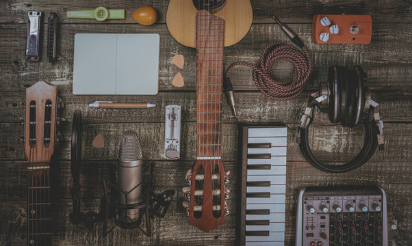 Singer, Songwriter, home recording and music producer flat lay concept. Ideal for home pages, diary, advertising, poster and so on. Lifestyle musician stuff on a vintage, aged, wooden table. Filtered