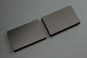 2 stack of black blank textured business cards on dark paper background, us size 3.5 x 2 inches, as...