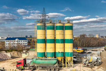 Concrete mixing plant. Four vertical towers for storing cement