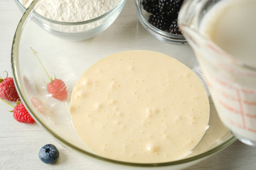 The process of making dough for pancakes.