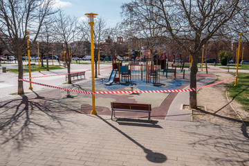 PALENCIA, SPAIN - MARCH 13, 2020: closed and empty children playgrounds in Spain because of coronavirus pandemic, covid-19, crisis