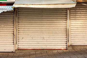 closed shutters of street shops