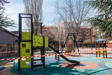 Fototapeta na wymiar PALENCIA, SPAIN - MARCH 13, 2020: closed and empty children playgrounds in Spain because of coronavirus pandemic, covid-19, crisis