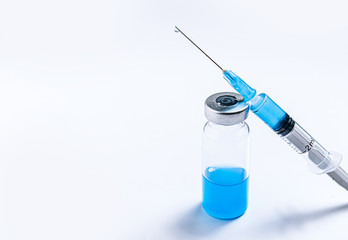 syringe and ampoule on a blue background