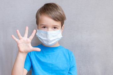 Portrait of Toddler kid wearing medical mask.A boy wearing mouth mask against air smog pollution....