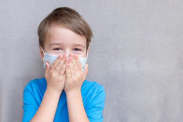 Portrait of Toddler kid wearing medical mask.A boy wearing mouth mask against air smog pollution....