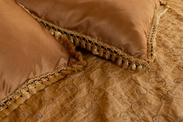 Luxurious pillows with fringes in bed