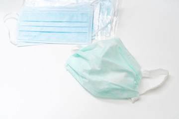 Fototapeta premium Surgical mask with rubber ear straps. Typical 3-ply surgical mask to cover the mouth and nose. Procedure mask from bacteria. Protection concept.
