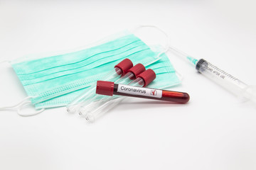 Coronavirus blood test concept. A test tubes with Coronavirus positive blood over laboratory desk. Covid-19 concept can be used in design