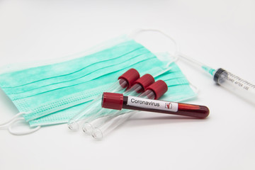 Coronavirus blood test concept. A test tubes with Coronavirus positive blood over laboratory desk. Covid-19 concept can be used in design