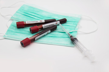 Coronavirus blood test concept. A test tubes with Coronavirus positive blood over laboratory desk. Covid-19 concept can be used in design