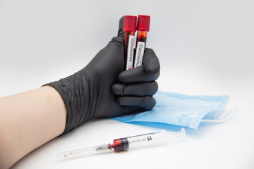 Coronavirus blood test 2019.Coronavirus came from Wuhan, China. Doctor hand in medical glove holding test tubes with Coronavirus positive blood in laboratory. Concept can be used in the design