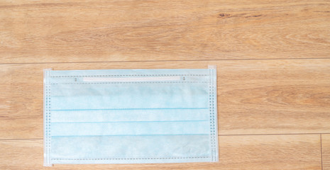 Surgical mask with rubber ear straps. Typical 3-ply surgical mask to cover the mouth and nose. Procedure mask from bacteria. Protection concept.