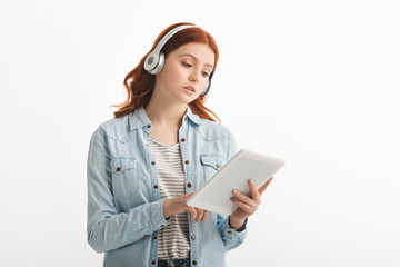 beautiful teenager listening music with headphones and digital tablet, isolated on white