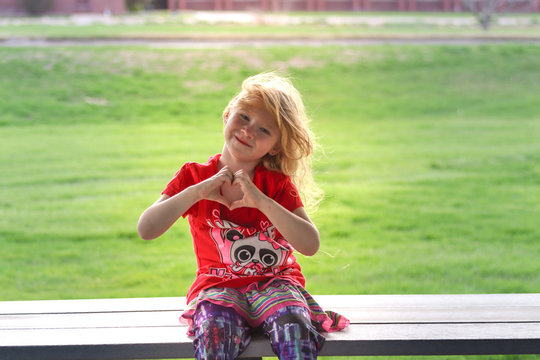 A little girl sitting in a park. High quality photo