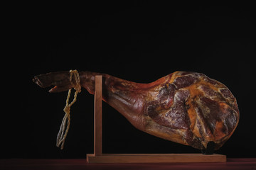 Dry Spanish ham, Jamon Serrano, Bellota, Italian Prosciutto Crudo or Parma ham, whole leg isolated on black background