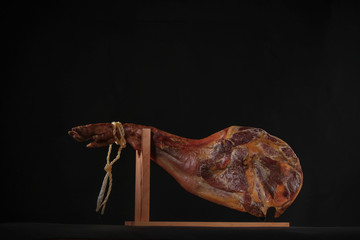 Dry Spanish ham, Jamon Serrano, Bellota, Italian Prosciutto Crudo or Parma ham, whole leg isolated on black background