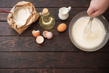 dough  and products for its preparation on  dark wooden backgrou
