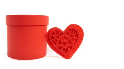 Valentine's Day concept. Red openwork heart, red gift box with copy space for text. White...