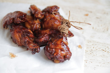  fried chicken wings with the addition of soy sauce and chili, aesthetically laid out on a marble table