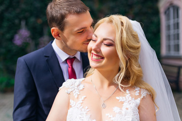 the happy bride smiled sincerely and closed her eyes. sunlight s