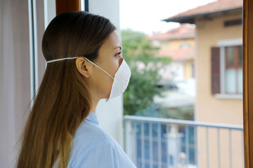 COVID-19 Pandemic Coronavirus Woman home isolation auto quarantine wearing face mask protective for...