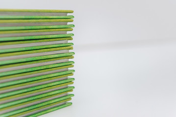 a large stack of blue-green books lies on a white surface. finished products of printed photobooks on a light background