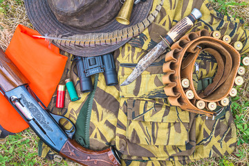 Hunting equipment on camouflage outdoors. Top view