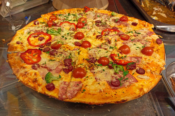 Cooking delicious pizza in the kitchen. Italian pizza on the counter after baking.