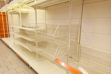 Empty shelves in the store. Sale of goods. Concept: deficit, epidemic, pandemic. Demand for goods.