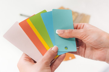 a set of color sample cards on a light background. color plates with the texture of different products. top view for color and material selection